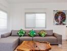 Modern living room with a sectional sofa, wooden coffee table, and artwork on the wall