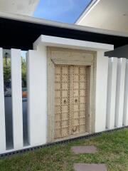 Front entrance with ornate wooden door