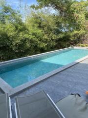 Outdoor swimming pool with surrounding greenery