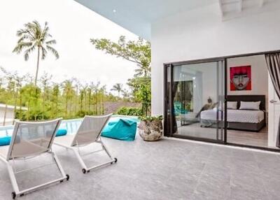Modern patio area with poolside view and adjacent bedroom