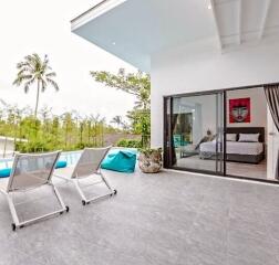 Modern patio area with poolside view and adjacent bedroom