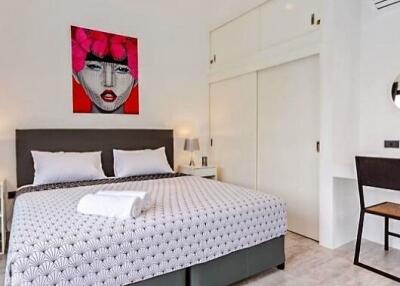 Stylish bedroom with modern art and double bed