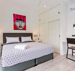 Stylish bedroom with modern art and double bed