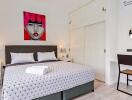 Stylish bedroom with modern art and double bed