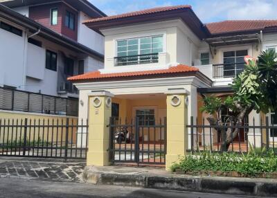 Exterior of a modern two-story house with a fenced yard