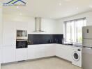 Modern kitchen with white cabinets and appliances