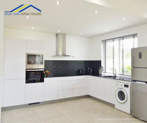 Modern kitchen with white cabinets and appliances