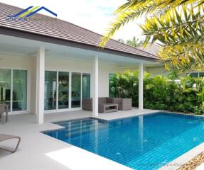 Outdoor patio with swimming pool and seating area