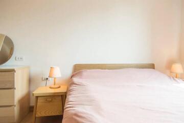 Cozy bedroom with wooden furniture and pink bedding