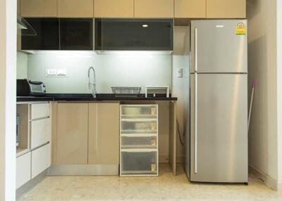 Modern kitchen with stainless steel refrigerator and cabinets