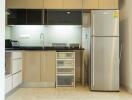 Modern kitchen with stainless steel refrigerator and cabinets