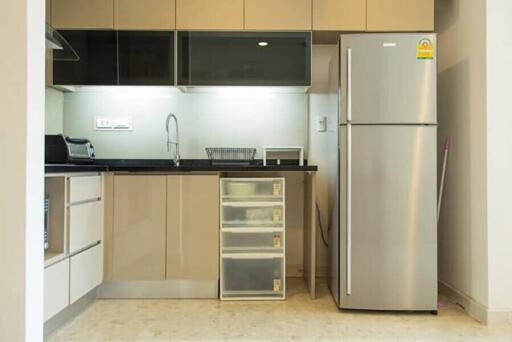 Modern kitchen with stainless steel refrigerator and cabinets