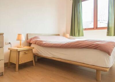 minimalist bedroom with wooden furniture and natural light