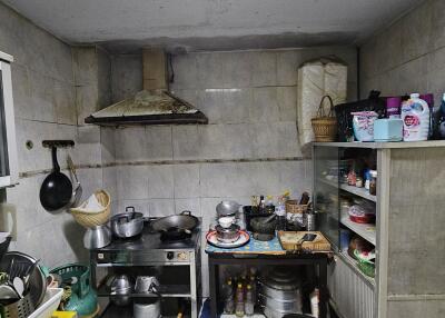 Simple kitchen with various utensils and a metal shelf