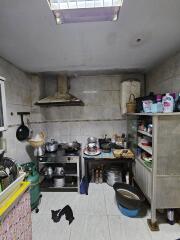 Simple kitchen with various utensils and a metal shelf