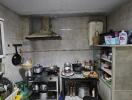 Simple kitchen with various utensils and a metal shelf