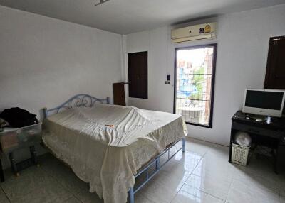 Spacious bedroom with large window and natural light