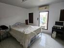 Spacious bedroom with large window and natural light