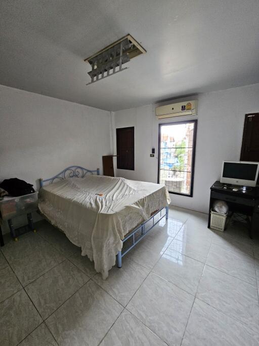 Spacious bedroom with large window and natural light