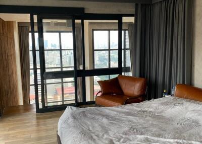 Bedroom with large windows and city view