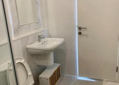 Bathroom with toilet, sink, and mirror