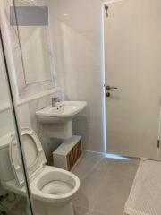 Bathroom with toilet, sink, and mirror