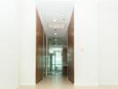 Bright hallway with wooden cabinets and glass door