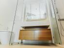 Modern bathroom with glass shower doors and wooden vanity