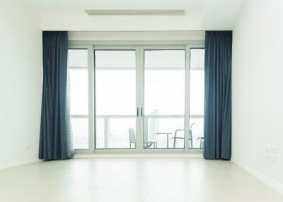 Bright living room with large glass sliding doors leading to a balcony