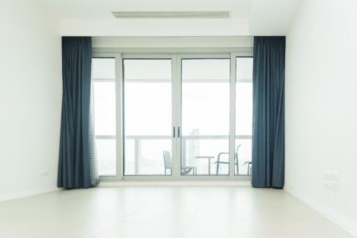 Bright living room with large glass sliding doors leading to a balcony