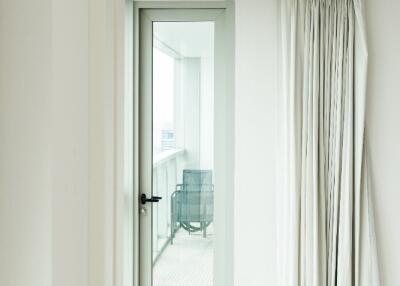 View of a balcony through a glass door from an indoor space