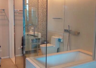 Modern bathroom with glass enclosed shower and bathtub