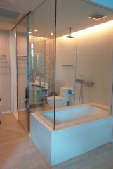 Modern bathroom with glass enclosed shower and bathtub