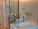 Modern bathroom with glass enclosed shower and bathtub