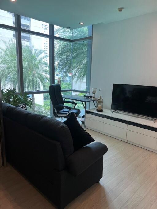 Modern living room with large windows and a city view