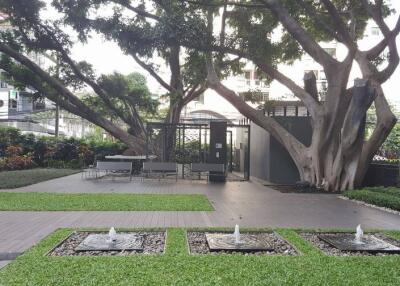 Green garden area with fountains and seating