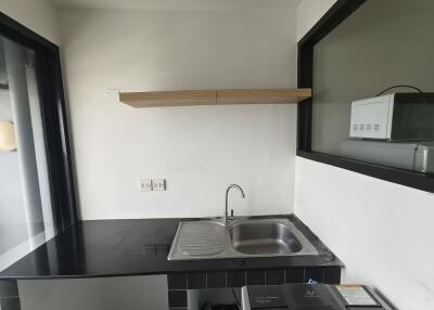 Modern kitchen with black countertop and sink