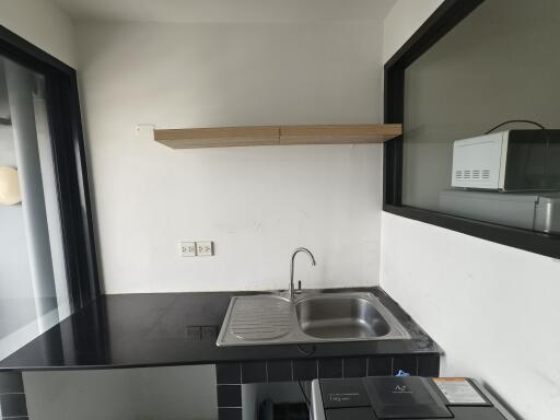 Modern kitchen with black countertop and sink