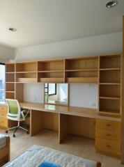 Bedroom with study area featuring built-in shelves and desk