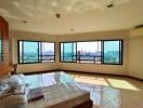 Bright bedroom with large corner windows and city view