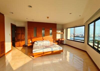 Spacious bedroom with large windows and city view