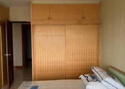 Bedroom with double bed and wooden wardrobe
