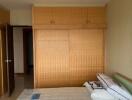 Bedroom with double bed and wooden wardrobe