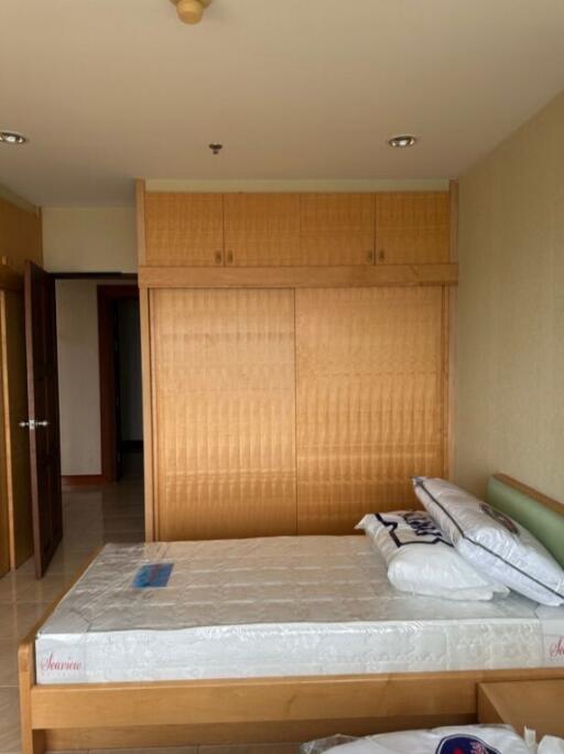 Bedroom with double bed and wooden wardrobe