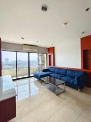 Spacious living room with large windows and city view