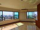 Spacious living area with large windows offering city views