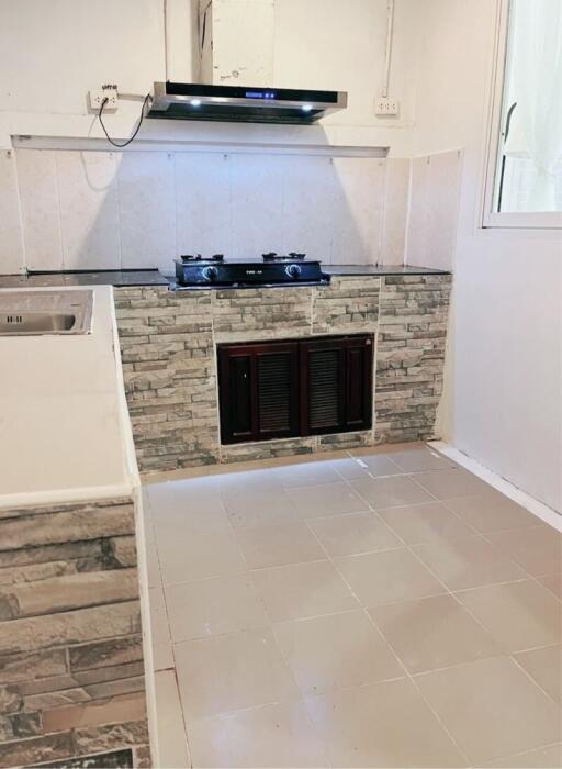 Modern kitchen with tiled walls and built-in stove