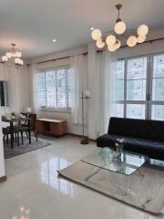 Modern living room with large windows and contemporary furnishings