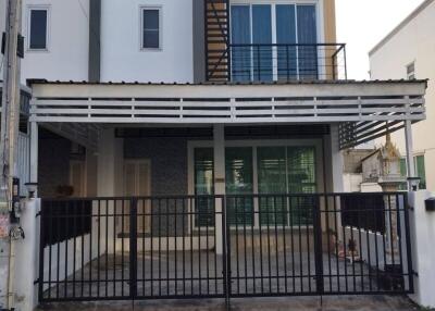 Two-story residential building with gated entrance