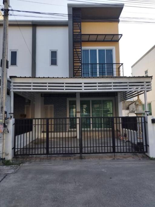 Two-story residential building with gated entrance